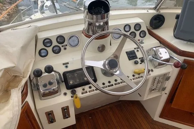 Slide: The Image of 1985 Gulfstar MK2 yacht helm with instruments and wood paneling. - 9