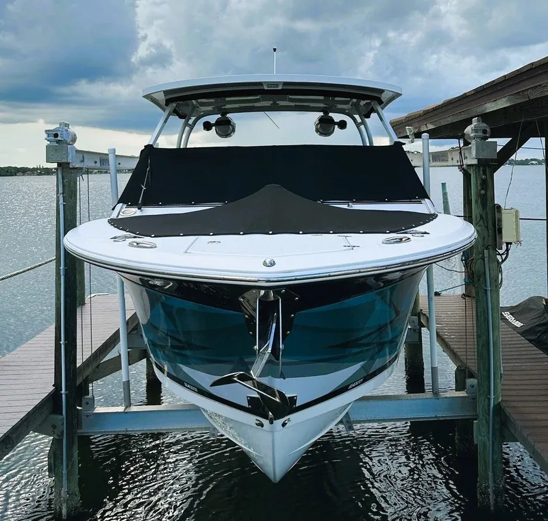 The Image of 2019 Blackfin 272 DC boat on a lift at the dock. - 0