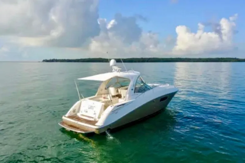 The Image of 2009 Sea Ray Sundancer 350 yacht on calm waters under a blue sky. - 0