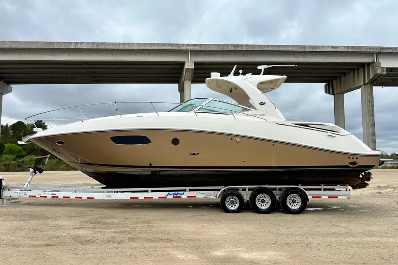 Slide: The Image of 2009 Sea Ray Sundancer 350 yacht on trailer under bridge, side view. - 1