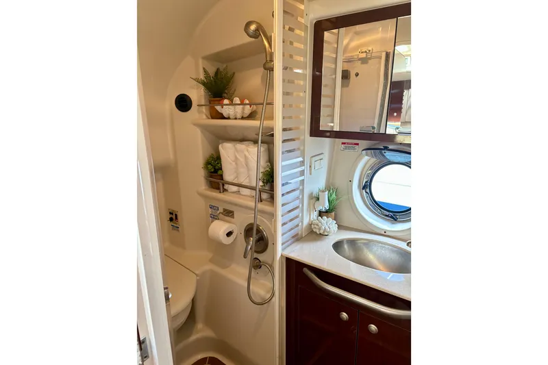 Slide: The Image of Compact bathroom in 2009 Sea Ray Sundancer 350 yacht with shower, sink, and porthole window. - 19