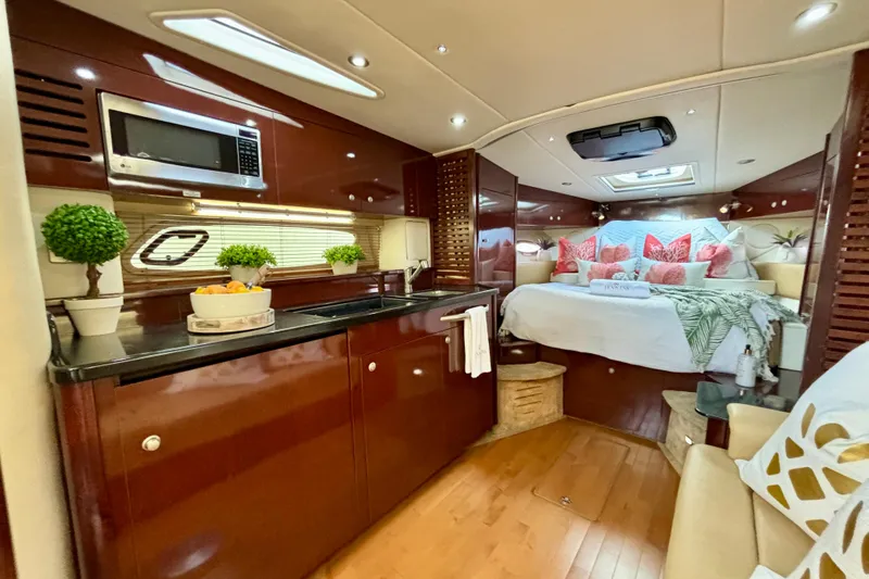 Slide: The Image of Luxurious interior of 2009 Sea Ray Sundancer 350 yacht with cozy bedroom and kitchenette. - 16