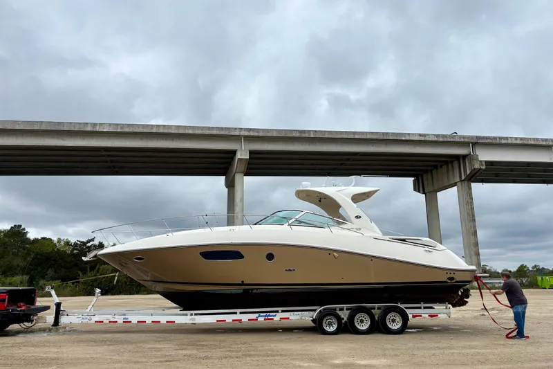 Slide: The Image of 2009 Sea Ray Sundancer 350 yacht on trailer under cloudy sky. - 4