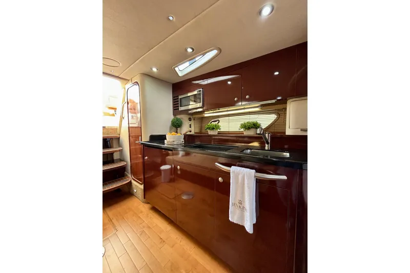 Slide: The Image of Luxurious 2009 Sea Ray Sundancer 350 yacht interior kitchen with modern amenities and elegant design. - 15