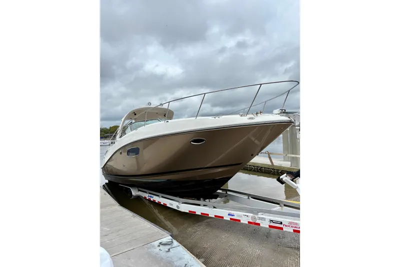 Slide: The Image of 2009 Sea Ray Sundancer 350 yacht on trailer at dock under cloudy sky. - 5