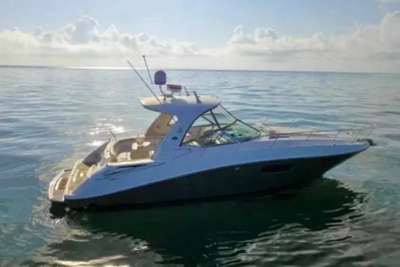 Slide: The Image of 2009 Sea Ray Sundancer 350 yacht on calm ocean waters under a cloudy sky. - 3