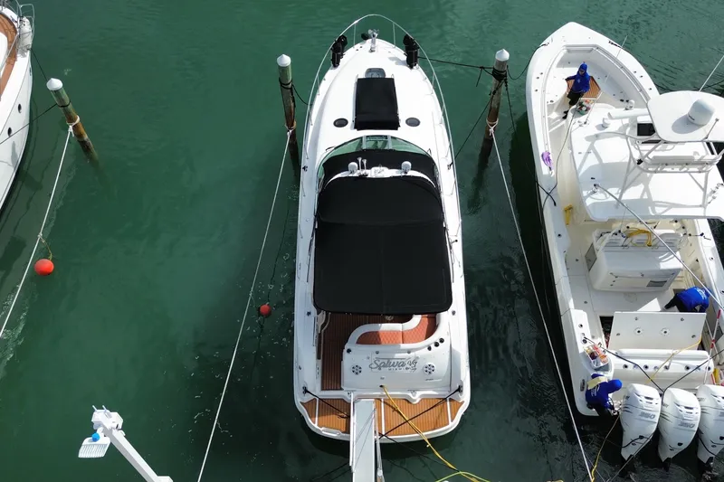 Slide: The Image of Overhead view of a 2004 Sea Ray 340 Sundancer docked between boats. - 10