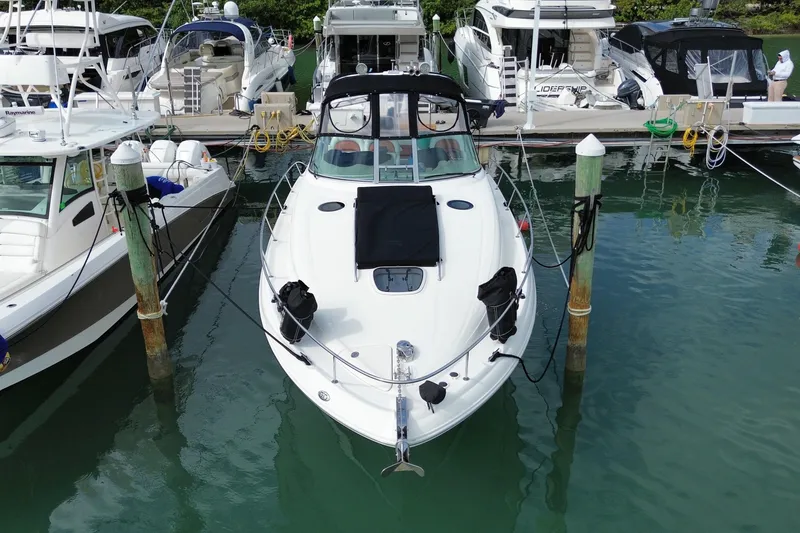 Slide: The Image of 2004 Sea Ray 340 Sundancer docked at marina, surrounded by other boats. - 11
