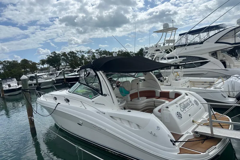 Slide: The Image of 2004 Sea Ray 340 Sundancer yacht docked at marina under cloudy sky. - 13
