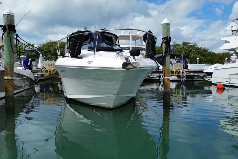 Slide: The Image of 2004 Sea Ray 340 Sundancer yacht docked at marina under cloudy sky. - 16