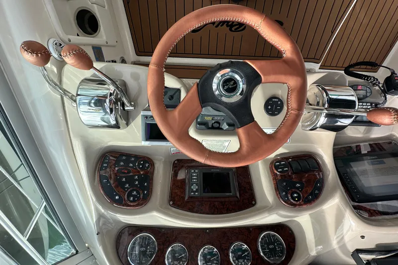 Slide: The Image of 2004 Sea Ray 340 Sundancer helm with leather steering wheel and control panel. - 25