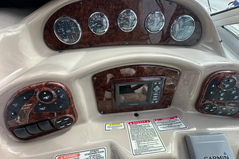 Slide: The Image of Dashboard of a 2004 Sea Ray 340 Sundancer boat with gauges and controls. - 28