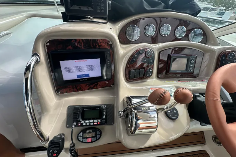 Slide: The Image of Dashboard of a 2004 Sea Ray 340 Sundancer boat with navigation controls and displays. - 29