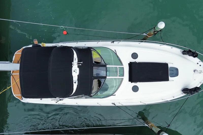 Slide: The Image of Overhead view of a 2004 Sea Ray 340 Sundancer yacht docked in calm waters. - 3