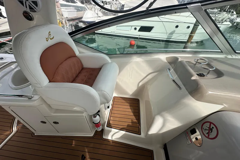 Slide: The Image of Captain's seat on 2004 Sea Ray 340 Sundancer, featuring luxurious design and marina view. - 31