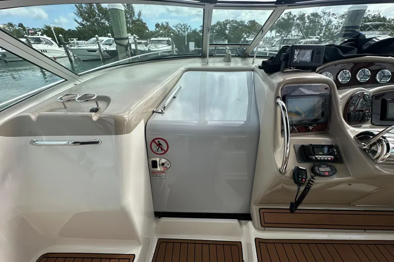 Slide: The Image of 2004 Sea Ray 340 Sundancer cockpit with navigation equipment and controls at marina. - 34