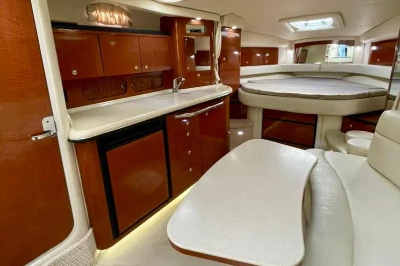 Slide: The Image of Luxurious interior of 2004 Sea Ray 340 Sundancer yacht with kitchenette and seating area. - 38