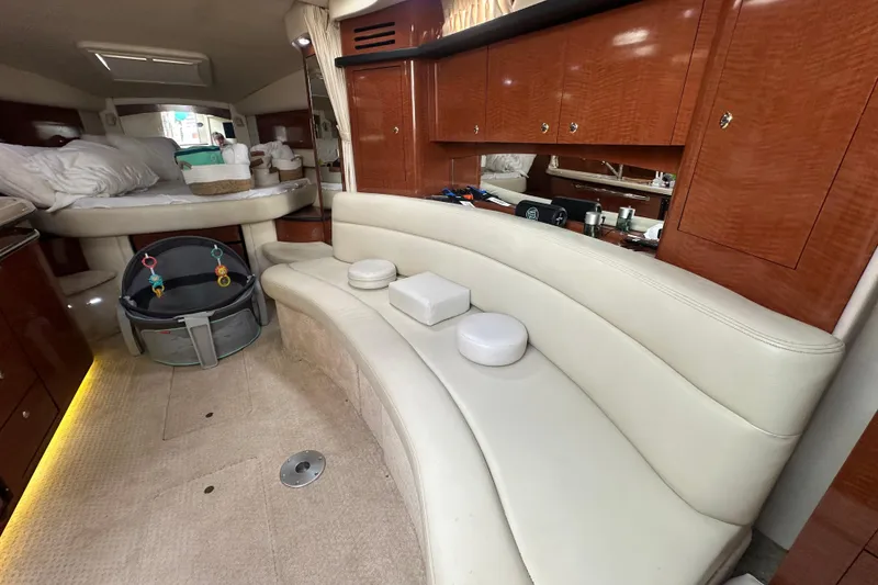 Slide: The Image of Luxurious interior of 2004 Sea Ray 340 Sundancer with plush seating and elegant wood cabinetry. - 40