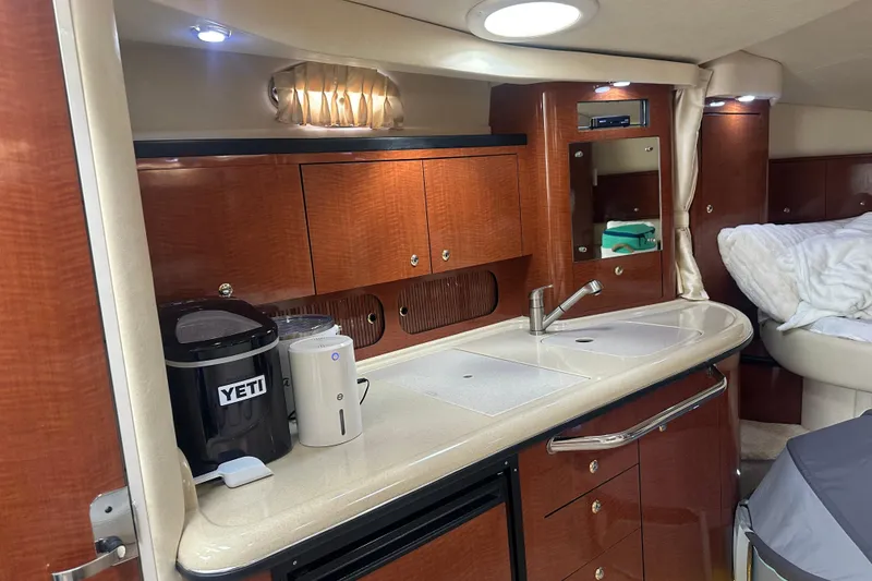 Slide: The Image of Luxurious 2004 Sea Ray 340 Sundancer cabin interior with kitchenette and modern amenities. - 45