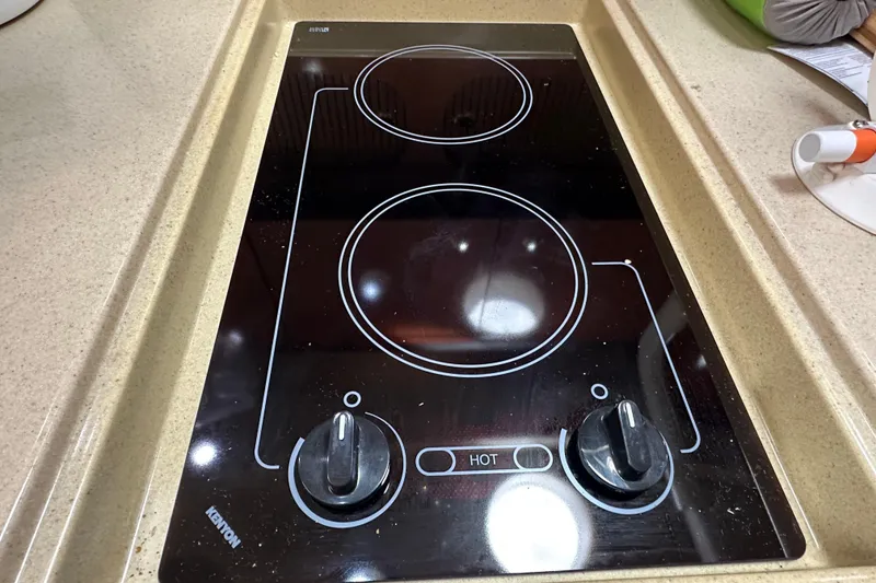 Slide: The Image of Built-in stovetop on 2004 Sea Ray 340 Sundancer yacht, featuring dual burners and control knobs. - 46