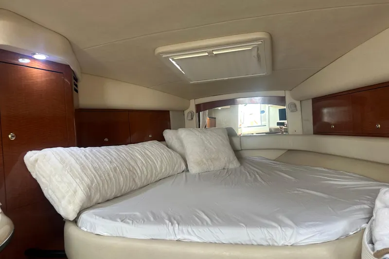 Slide: The Image of Luxurious cabin interior of 2004 Sea Ray 340 Sundancer yacht with plush bedding. - 49