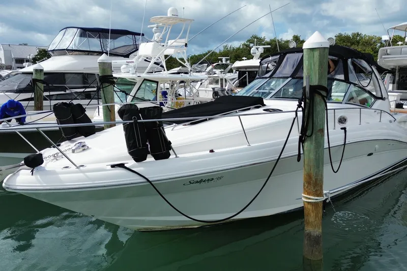 Slide: The Image of 2004 Sea Ray 340 Sundancer yacht docked in marina, surrounded by other boats. - 5