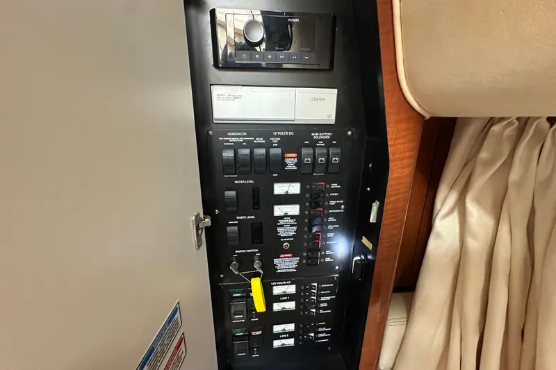 Slide: The Image of Electrical control panel on a 2004 Sea Ray 340 Sundancer boat interior. - 51