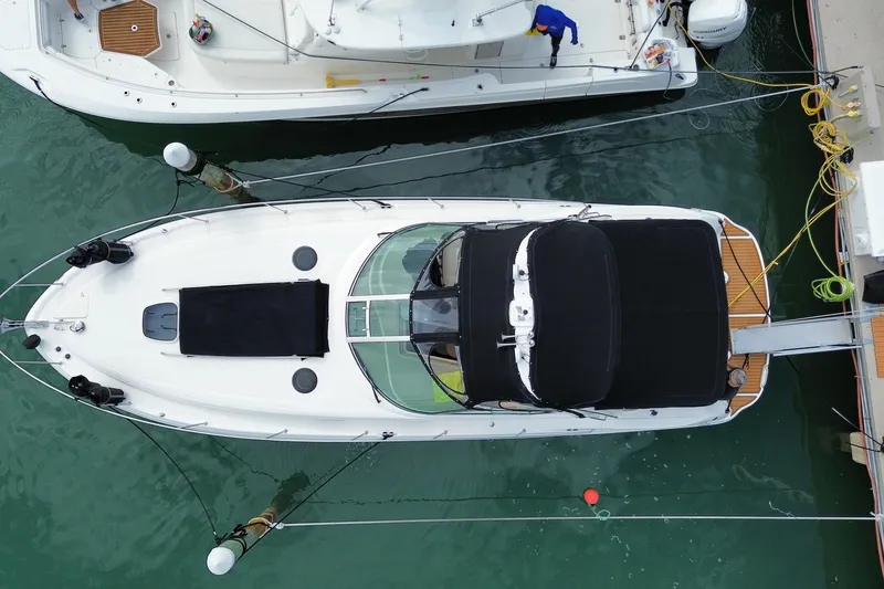 Slide: The Image of Overhead view of a 2004 Sea Ray 340 Sundancer docked at a marina. - 7