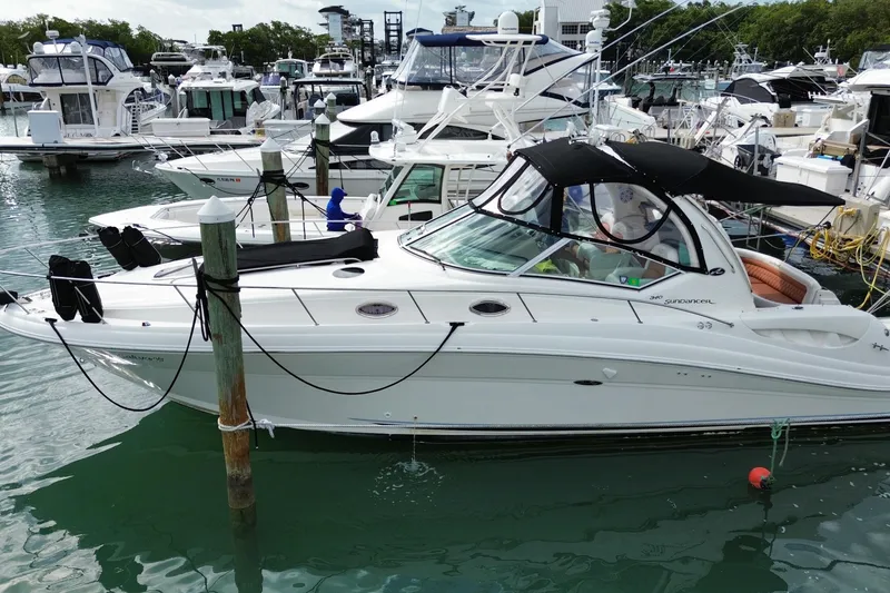 Slide: The Image of 2004 Sea Ray 340 Sundancer yacht docked in a marina with other boats. - 8
