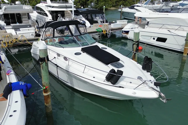 Slide: The Image of 2004 Sea Ray 340 Sundancer docked at marina, surrounded by other boats. - 9