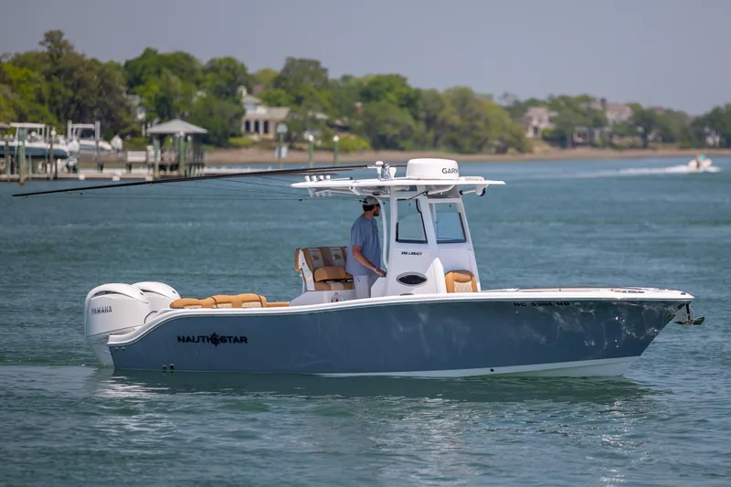 The Image of 2024 NauticStar 252 Legacy boat cruising on a serene waterway. - 1