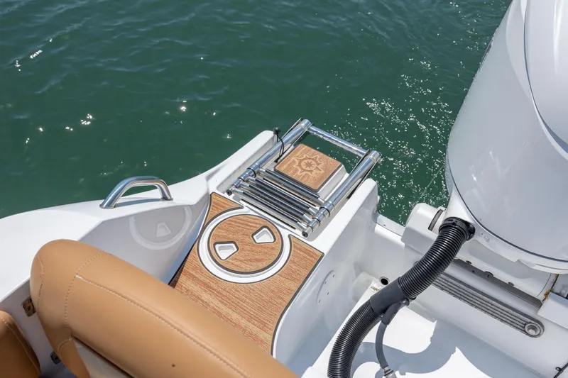 Slide: The Image of 2024 NauticStar 252 Legacy boat swim platform with ladder and teak accents. - 12