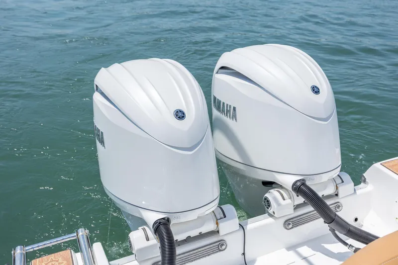Slide: The Image of Twin Yamaha outboard engines on a 2024 NauticStar 252 Legacy boat in water. - 13
