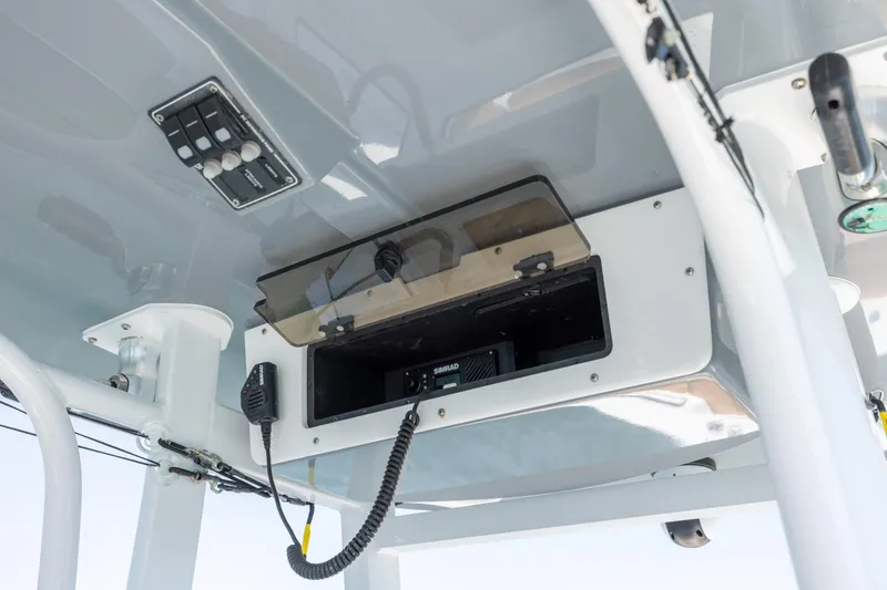 Slide: The Image of 2024 NauticStar 252 Legacy boat console with radio and control panel. - 22