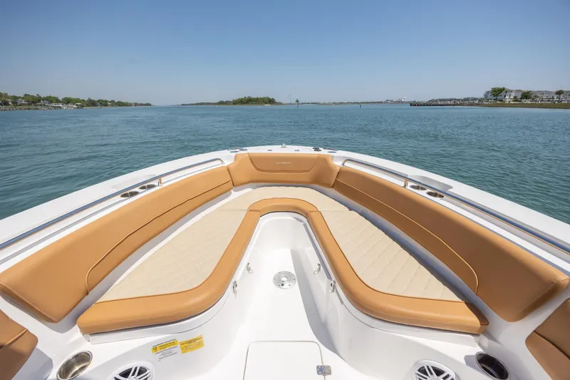 Slide: The Image of 2024 NauticStar 252 Legacy boat with tan seating, cruising on calm waters. - 29
