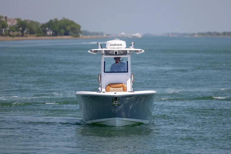 Slide: The Image of 2024 NauticStar 252 Legacy boat cruising on calm waters, featuring Garmin equipment. - 3
