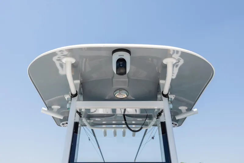 Slide: The Image of T-top view of 2024 NauticStar 252 Legacy boat against clear blue sky. - 31