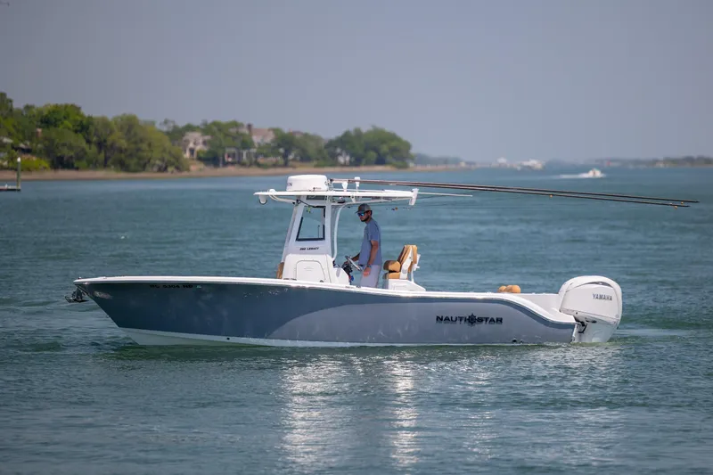 Slide: The Image of 2024 NauticStar 252 Legacy boat cruising on a calm waterway. - 5