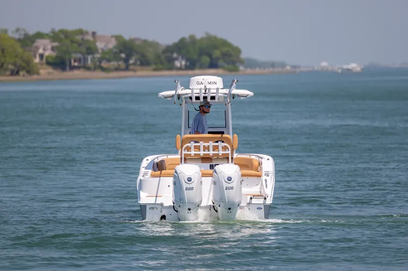 Slide: The Image of 2024 NauticStar 252 Legacy boat cruising on a calm waterway. - 7