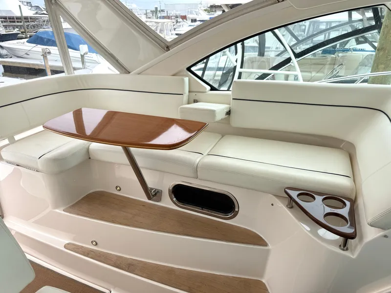 Slide: The Image of Interior of 2013 Tiara Yachts 3600 Coronet with wooden table and seating area. - 8