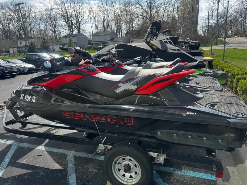 Slide: The Image of 2011 Sea-Doo RXT 260 jet ski parked on trailer outdoors. - 4