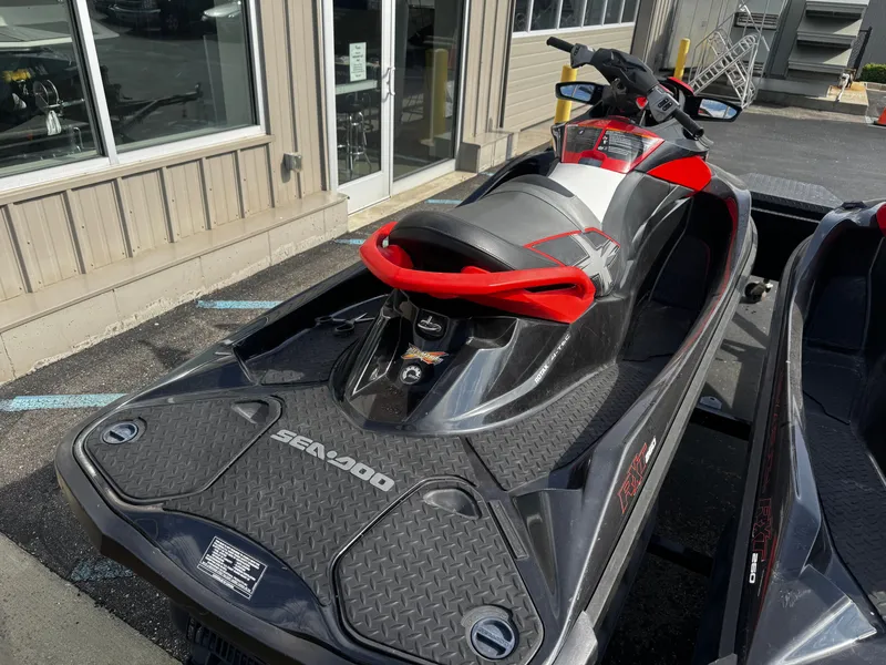 Slide: The Image of 2011 Sea-Doo RXT 260 jet ski parked outdoors. - 6