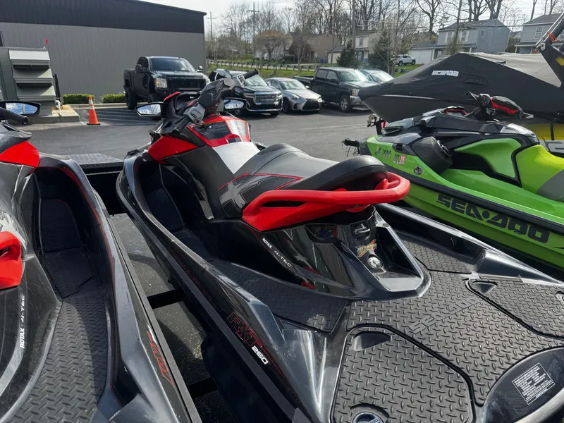 Slide: The Image of 2011 Sea-Doo RXT 260 jet ski parked outdoors. - 8