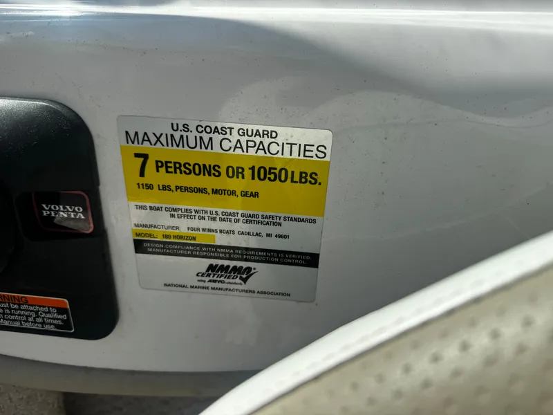 Slide: The Image of US Coast Guard capacity label on a 2006 Four Winns 180 Horizon boat. - 16