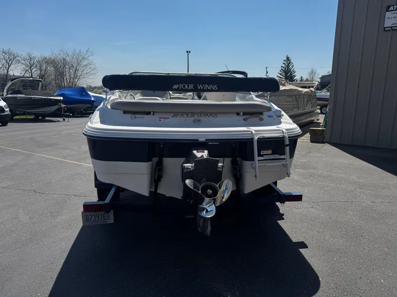 Slide: The Image of 2006 Four Winns 180 Horizon boat parked outdoors. - 17