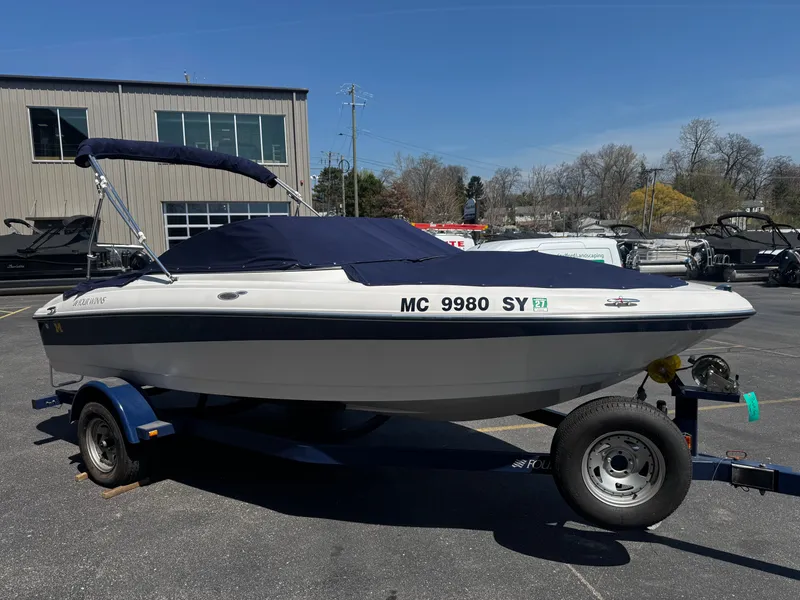 Slide: The Image of 2006 Four Winns 180 Horizon boat on trailer outdoors. - 18