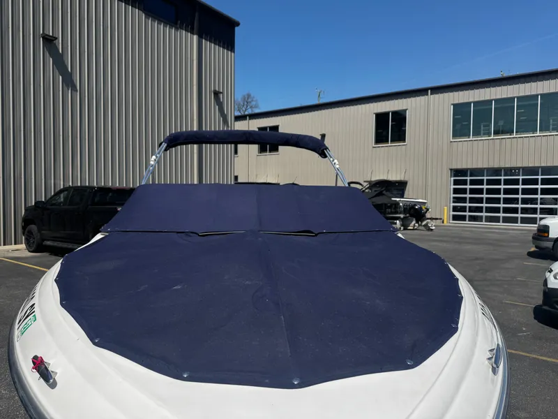 Slide: The Image of 2006 Four Winns 180 Horizon boat with cover in parking lot. - 19