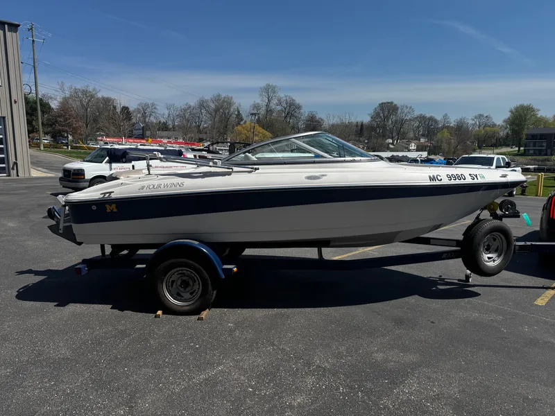 Slide: The Image of 2006 Four Winns 180 Horizon boat on trailer outdoors. - 2