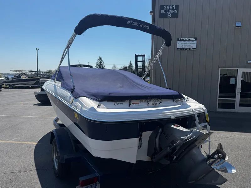 Slide: The Image of 2006 Four Winns 180 Horizon boat parked on trailer. - 21
