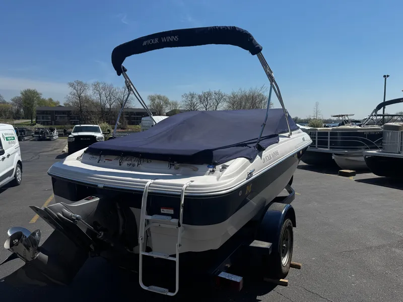 Slide: The Image of 2006 Four Winns 180 Horizon boat on trailer outdoors. - 22